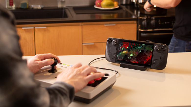Man playing on Steam Deck with fight stick