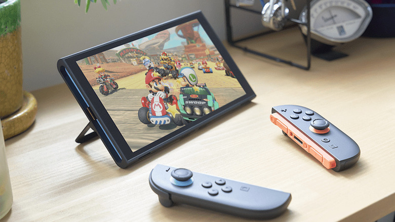 A Nintendo Switch running Mario Kart World with Joy-Con controllers on the table.