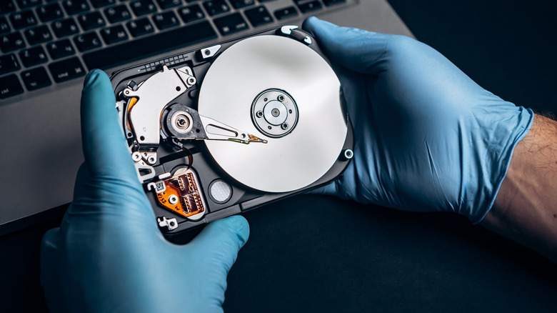Technician holding a hard disk drive