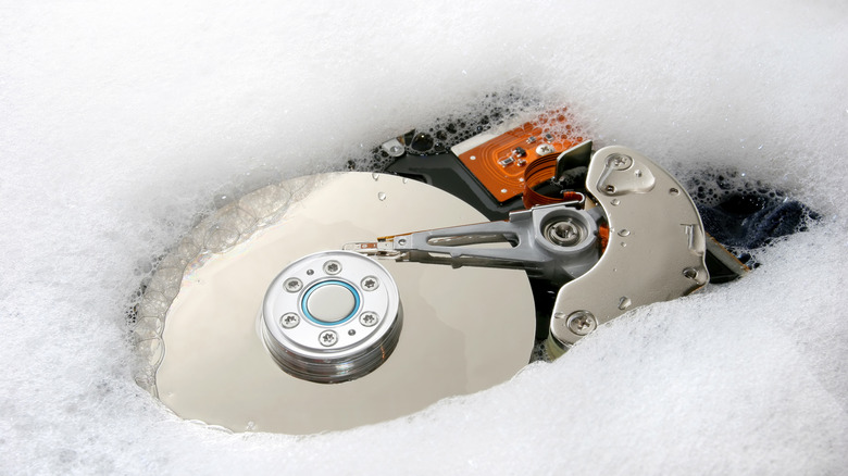 A hard drive sinking in soap suds