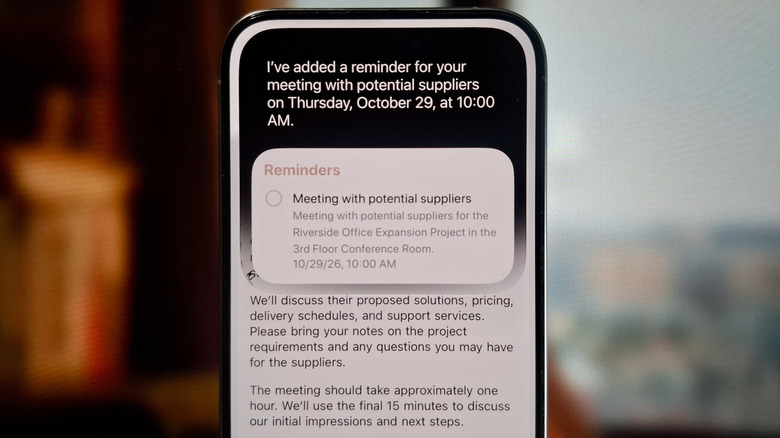 iPhone showing email about a meeting with Siri AI creating a reminder