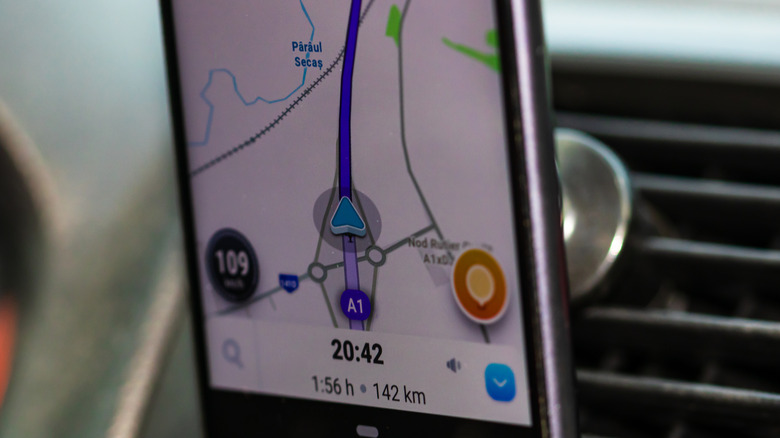 The speedometer is visible in the lower left corner during Waze navigation.