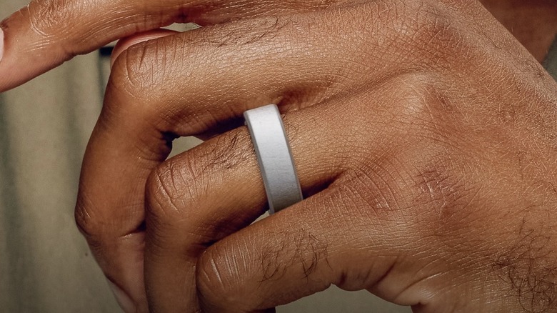 A close-up of the Oura Ring 4 worn on a finger.