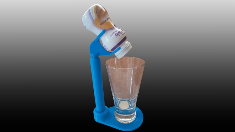 Fortisip pouring stand in use on a black to white gradient background