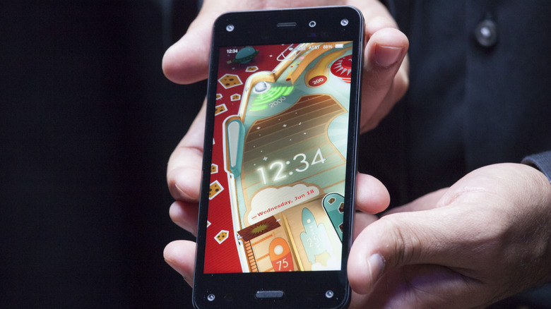 Amazon Fire Phone held in hand as it is revealed to audience