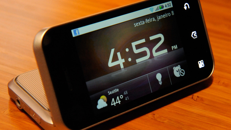 Motorola Backflip sitting on table with screen folded back to show clock and weather