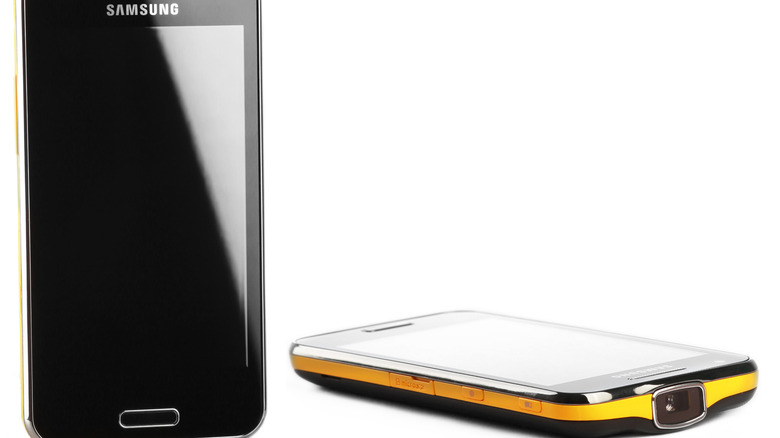 Samsung Galaxy Beam i8530 on white background showing front of phone as well as side profile with projector
