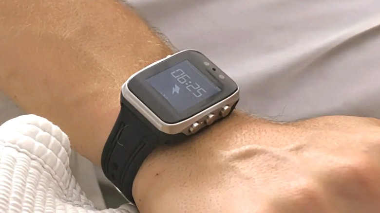 Someone in bed wearing the Shock Clock MAX
