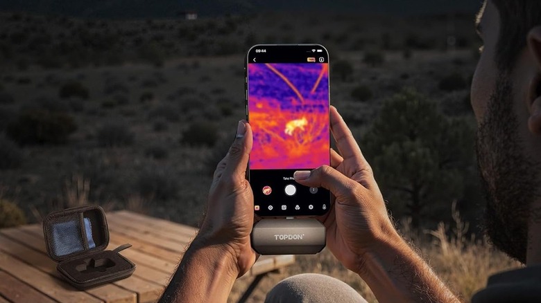A person using Topdon TC002 Duo Thermal Camera with their phone to see wildlife