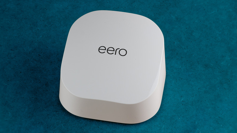 Amazon eero mesh router showing logo on top with blue background