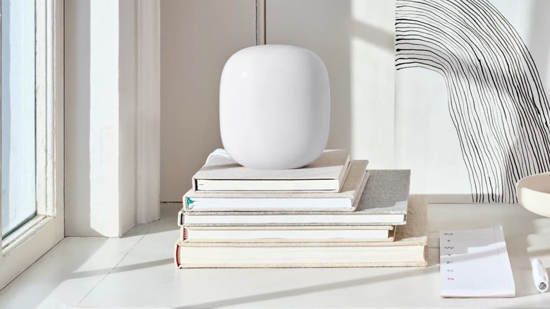 Nest Wifi Pro on top of book stack sitting on desk