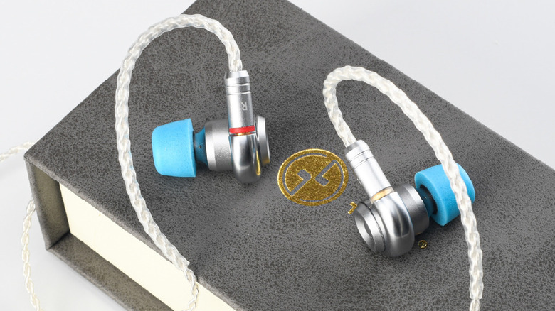 A closeup of the Tin HiFi T2 MKIII earphones resting on a retail package