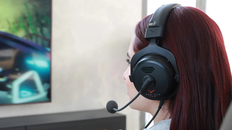 A person wearing the Beyerdynamic MMX 330 Pro wired gaming headset