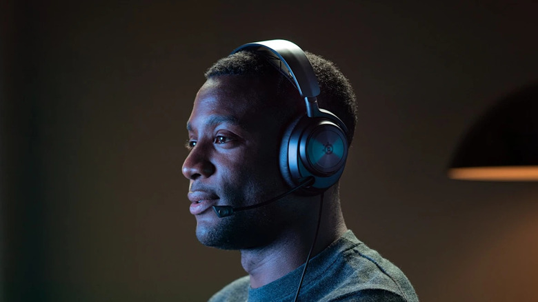 A person wearing the SteelSeries Arctis Nova Pro wired gaming headset