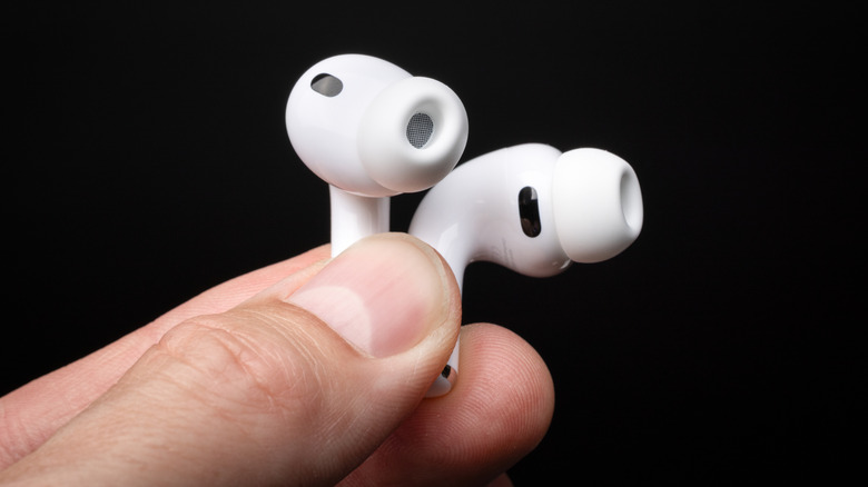 A person holding the AirPods Pro 3.