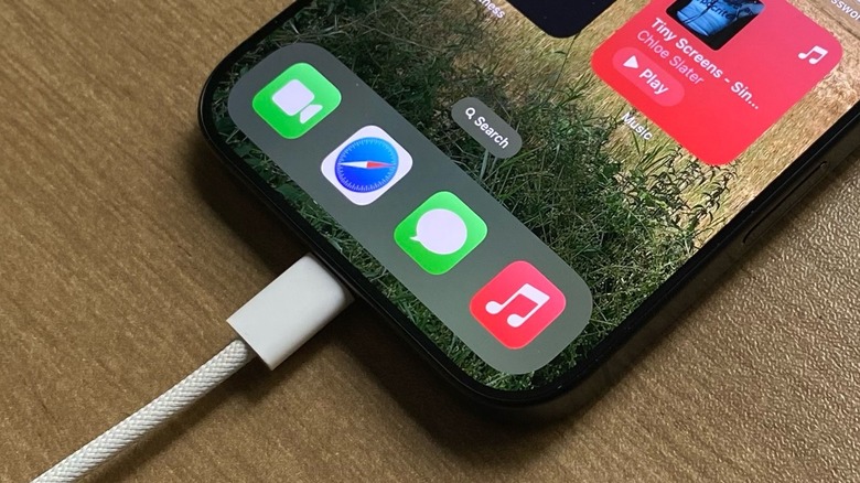 Close-up shot of an iPhone charging via a USB-C cable.