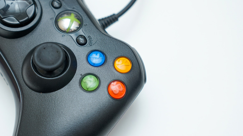 A close-up view of wired gamepad controller against a clean white background.