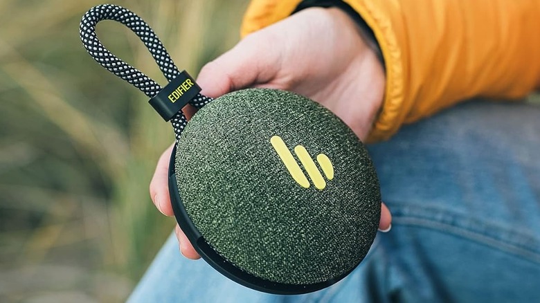 A person holding the Edifier MP100 Plus.