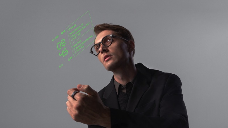 A user controlling the G2 Display Smart Glasses and the R1 Smart Ring.