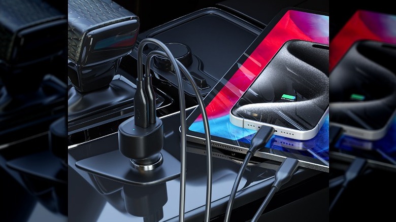 Car charger connected to an iPhone and a tablet.