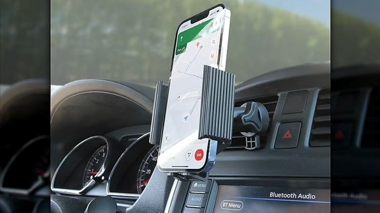 Phone mounted on a car mount attached to AC vents.
