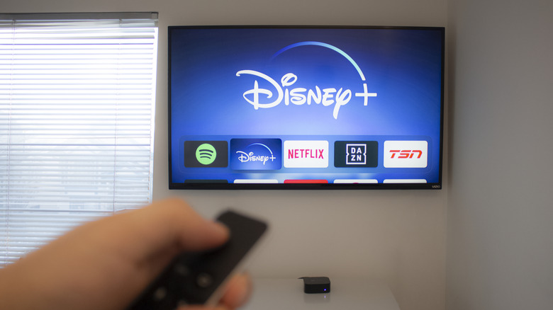 Man watching Disney+ on Vizio TV