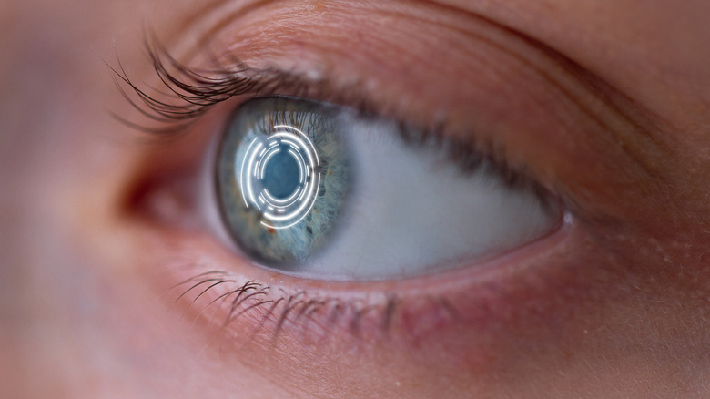 A person's eyeball reflecting a ring of light.