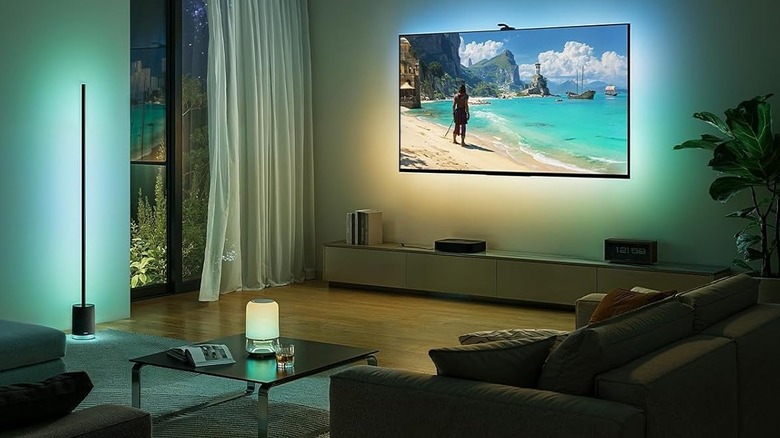 Govee Backlights on a large television in a living room, syncing with another lamp on the side