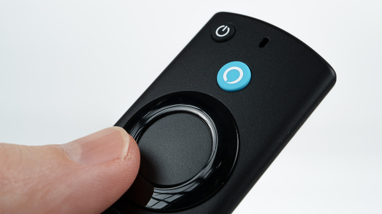Amazon Fire TV Stick remote control showing the blue voic control button