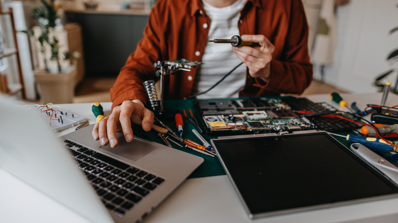 Person repairing a laptop