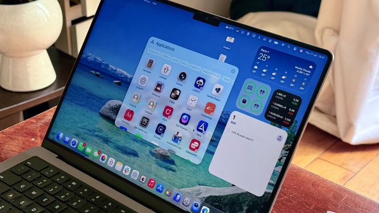 The new macOS Tahoe's Spotlight on a MacBook Pro