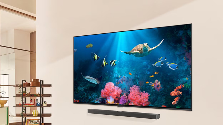 An LG 65QNED90TUA displays a vibrant seascape with turtles and tropical fish