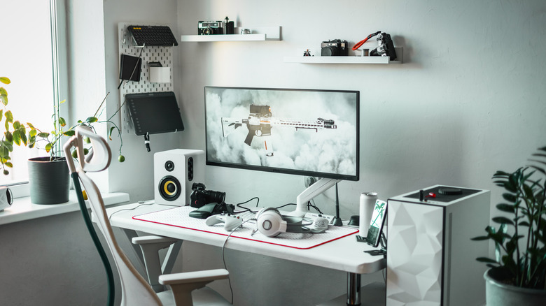 A gaming setup with an ultrawide monitor