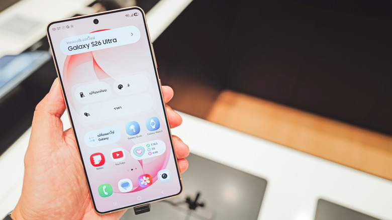 holding a Galaxy Android phone