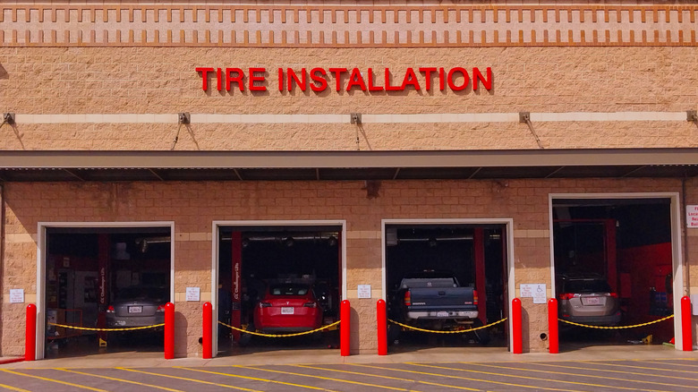 Cars in the tire installation area of a Costco Tire Center.