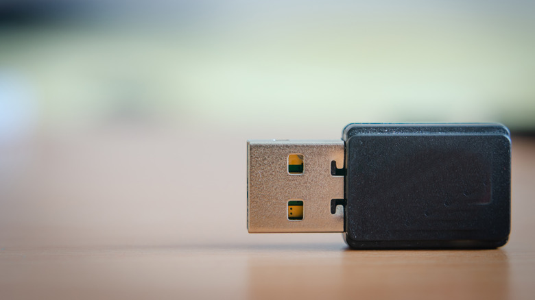 A Bluetooth USB adapter on a flat surface.