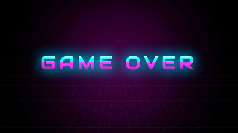 Retro-style "GAME OVER" text glowing in neon blue and pink against a dark grid background inspired by 1980s arcade graphics.