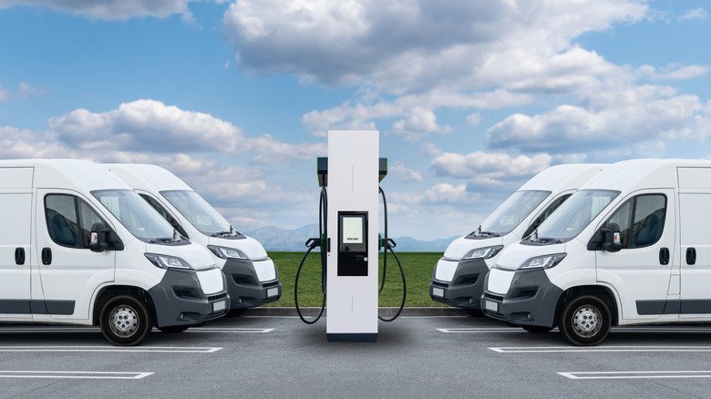 A woman and child plugging the charger of their EV.