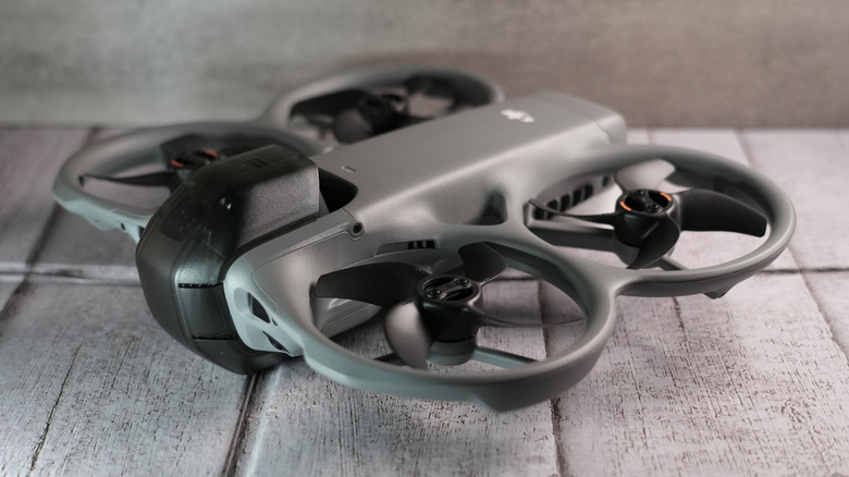 The DJI Avata 360 placed on a gray wooden surface