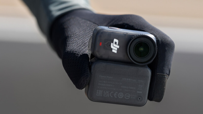 The DJI Osmo Nano being held by a gloved hand