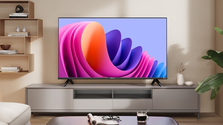 TV screen with a colorful display placed on a living room TV table.