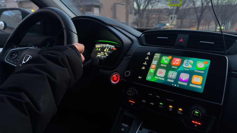 Driver's-side car interior showing Apple CarPlay