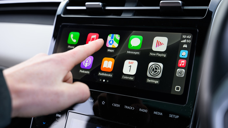 Hand Interacting with Apple CarPlay in Vehicle