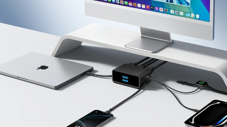 The Anker Nano Charging Station tucked under a monitor with a MacBook, iPhone, iPad, and Apple Watch connected.