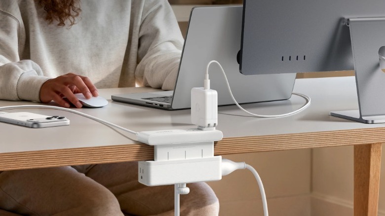 Anker Nano Desk Clamp Power Strip attached to a table with a MacBook and monitor plugged into it.