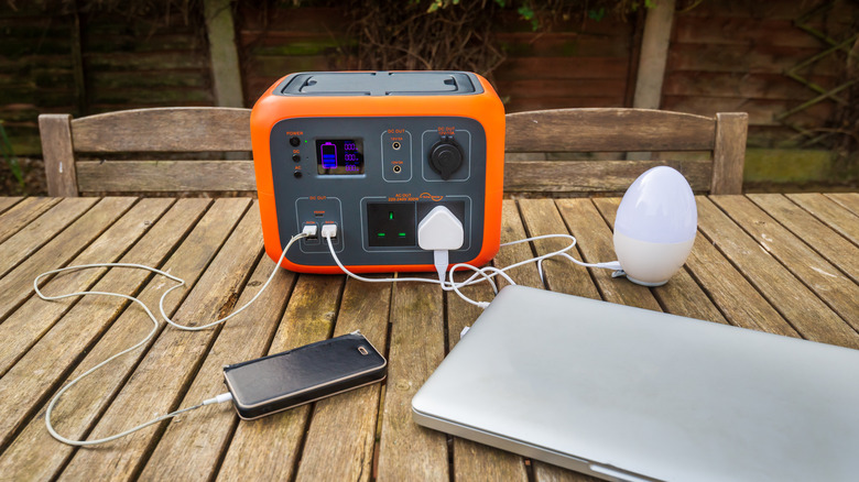 Laptop drawing power off a power station alongside other devices