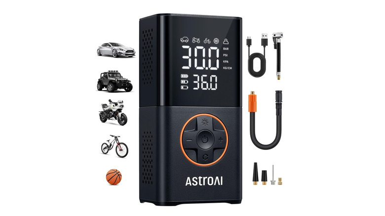 A black rectangular tire button with an orange-bordered directional control panel and an LED screen against a white background.