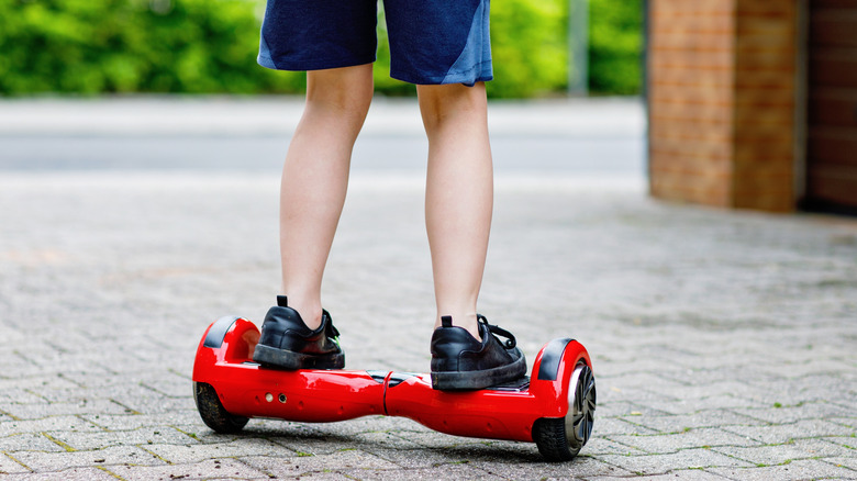 A kid ride on a self balancing hoverboard