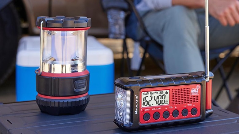 An emergency radio and a lantern placed on a flat surface