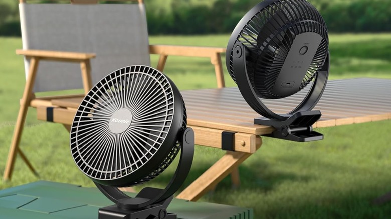 One Koonie portable fan placed on a flat surface and another clipped onto a table
